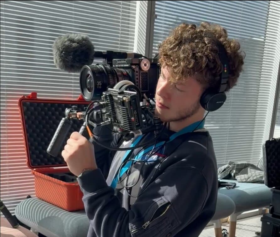 Teo Lister holding a camera on set